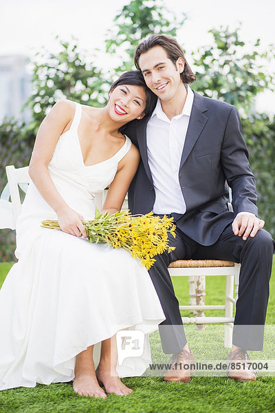 Newlywed couple smiling outdoors