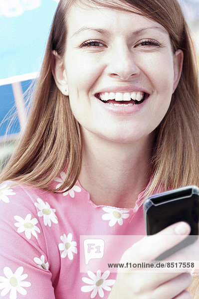 Smiling woman holding cell phone
