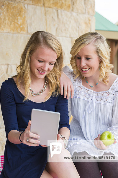 USA  Texas  teenage girls using mini tablet pc