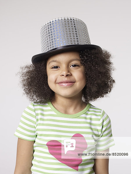 Smiling girl wearing top hat