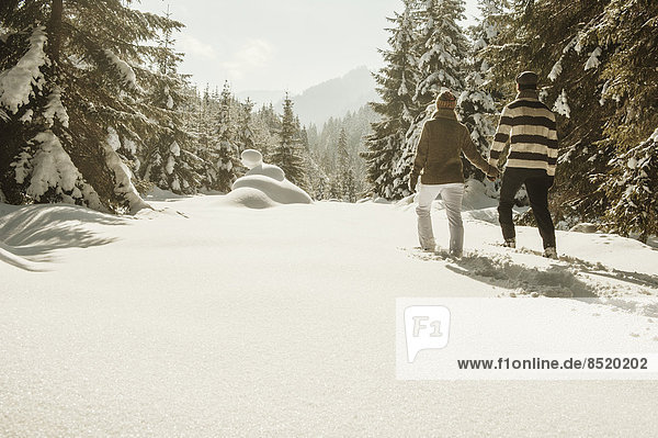 Austria  Salzburg State  Altenmarkt-Zauchensee  Couple snowshoeing in winter landscape