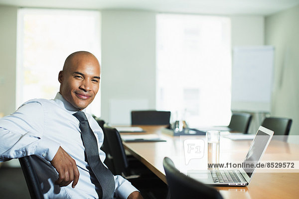 Businessman smiling at conference table
