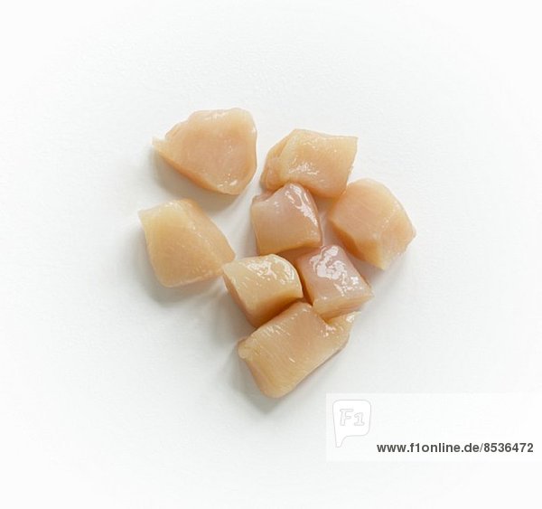 Raw Cubed Chicken on a White Background