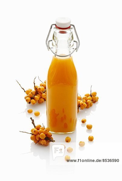 Sea buckthorn juice in a stoppered bottle