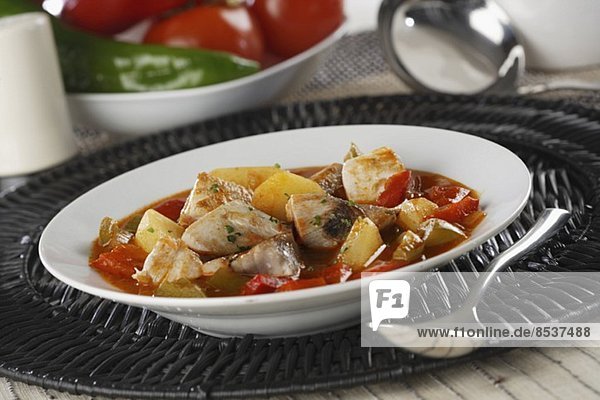 Marmitako (fish soup with potatoes  peppers and tomatoes)