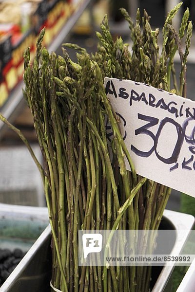 Wild asparagus at the market with a price sign