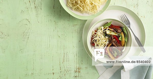 Fried beef with peppers  baby sweetcorn and noodles