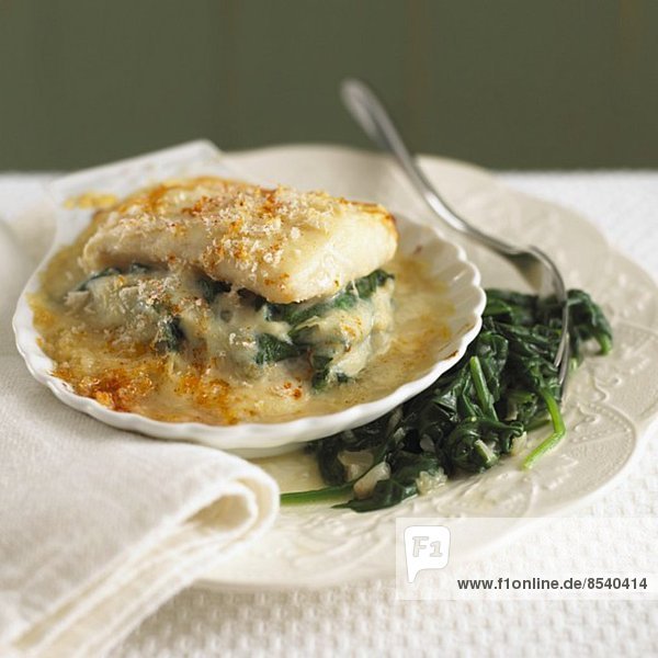 Haddock baked with cheese  served with spinach