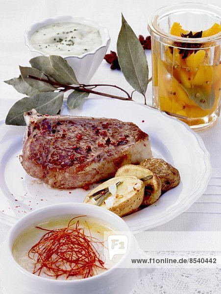 A meal of chilli soup  a veal chop and preserved peaches