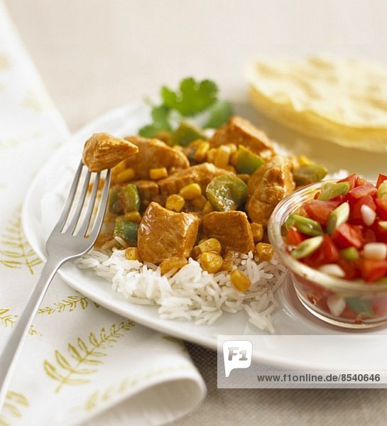 Chicken curry with sweetcorn and peppers on a bed of rice