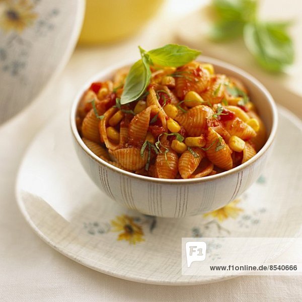 Pasta shells with tomato sauce  sweetcorn and basil