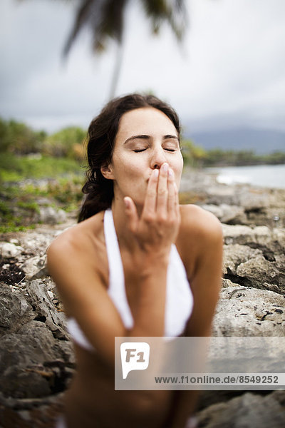 Young woman blowing a kiss at Las Galeras  Samana Peninsula  Dominican Republic.