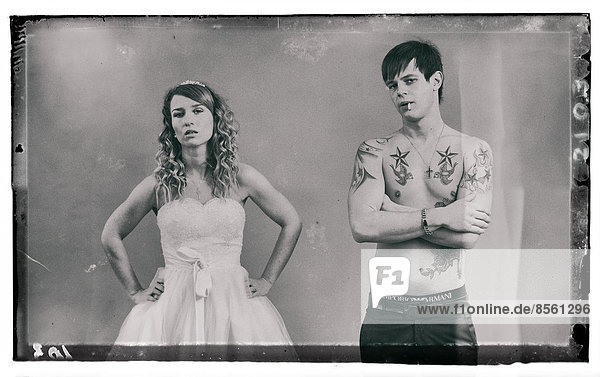 Wedding picture  bride and groom  bare chested groom with tattoos and a cigarette