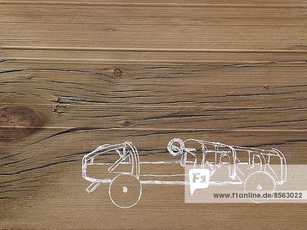 Ein Linienzeichnungsbild auf einem Hintergrund mit natürlicher Holzmaserung. Seitenprofil eines niedrigen  sportlichen  oben offenen Wagenchassis.