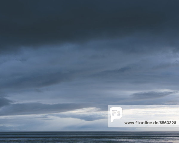 Das Meer und der Himmel über dem Puget Sound in Washington  USA. Der Horizont mit Licht- und Wolkenschichten darüber. Aufziehende Gewitterwolken.