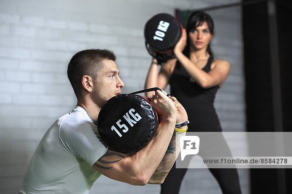 France  couple in crossfit gymnasium.