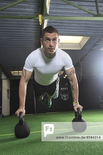 France  man exercising in a crossfit gymnasium..