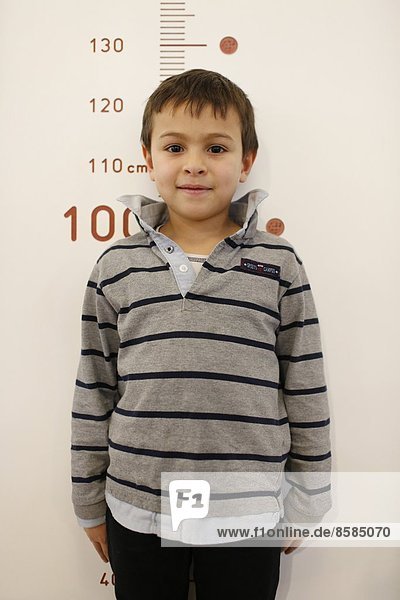 Boy measuring his height. Paris. France.