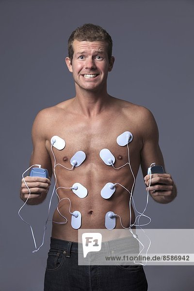 France  young man doing electrical muscle stimulation.