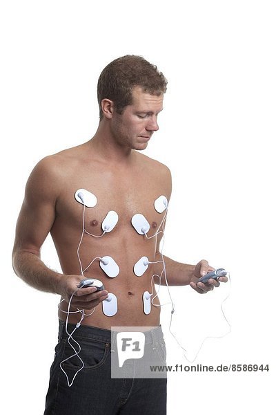 France  young man doing electrical muscle stimulation.