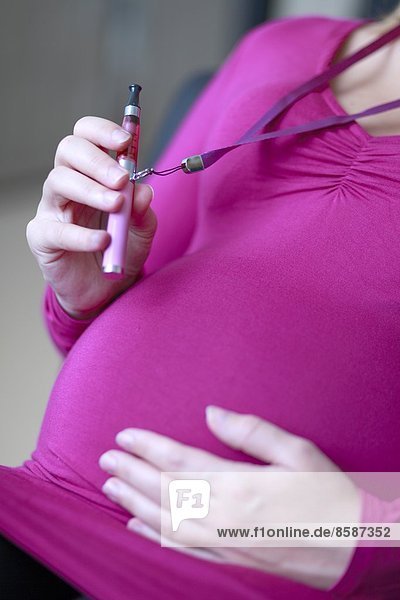 Frankreich  schwangere Frau mit elektronischer Zigarette.