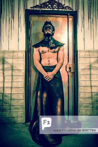 Man standing guard an evil door