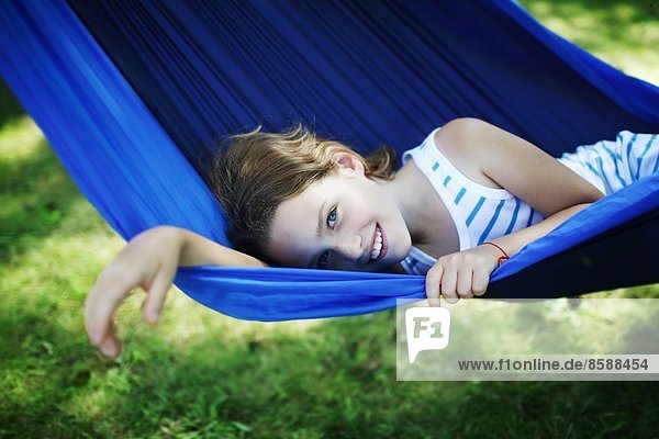 Young girl resting in hammock