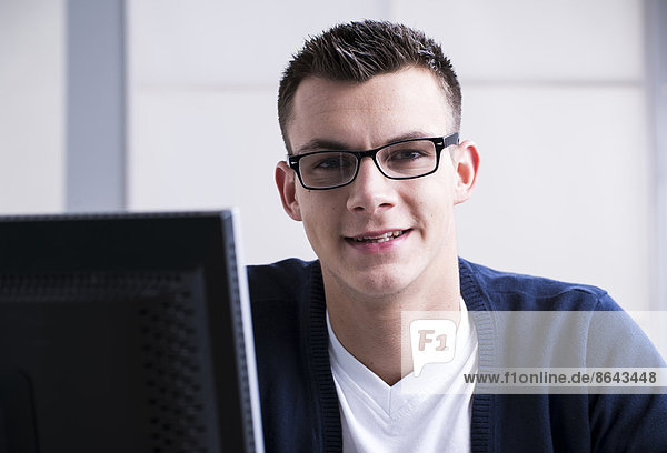 Young man sitting at desk