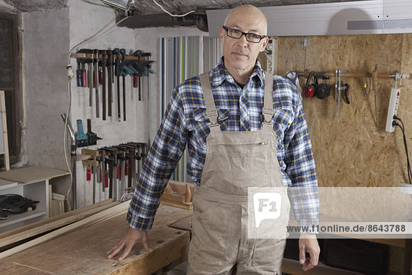 Mature man standing in carpenter shop  portrait