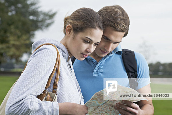 Young couple looking at map