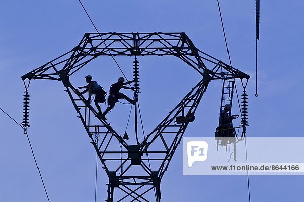 Workers on pylon  Brittany  France  Europe