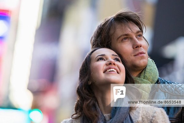 Young couple on vacation looking up  New York City  USA