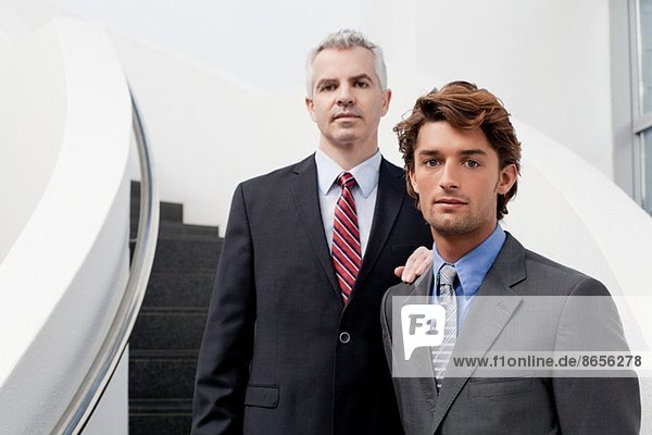 Porträt von zwei Geschäftsleuten auf einer Bürotreppe