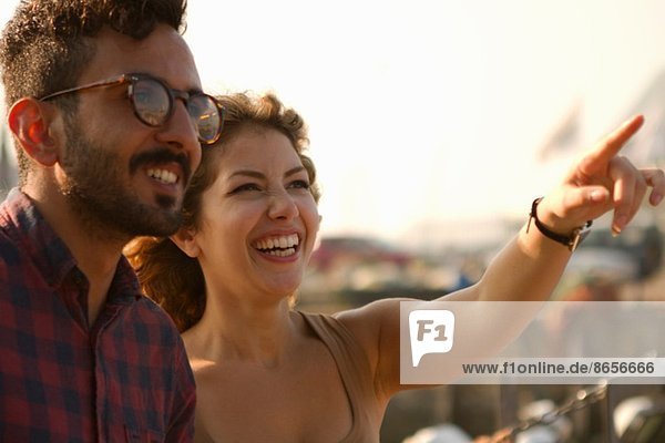 Young couple laughing  woman pointing