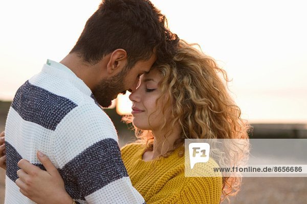 Young couple hugging on beach