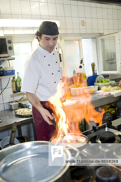 Flambé cooking in a kitchen  Italian restaurant  Upper Bavaria  Bavaria  Munich  Germany