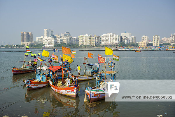 The skyline of the suburb Churchgate seen across the Back Bay with some fishing boats  Mumbai  Maharashtra  India