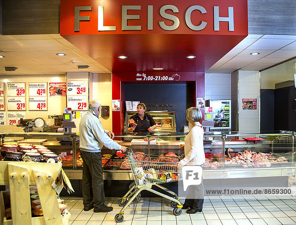Senior couple shopping at the meat counter in the supermarket  Germany