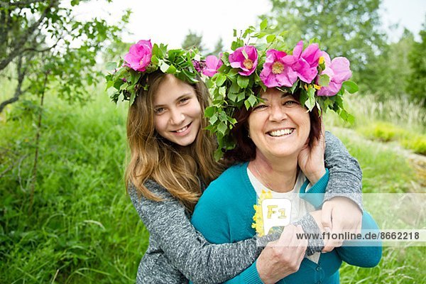 Portrait of mother and daughter wearing wreaths of flowers  Nykoping  Sodermanland  Sweden