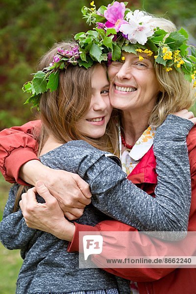 Grandmother with granddaughter wearing flower wreaths  Nykoping  Sodermanland  Sweden
