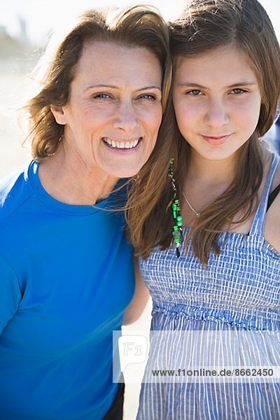 Mother with teenage daughter on beach