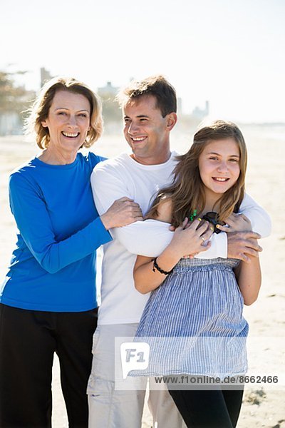 Parents with teenage daughter on beach
