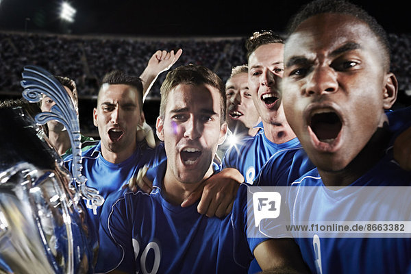 Soccer team cheering on field