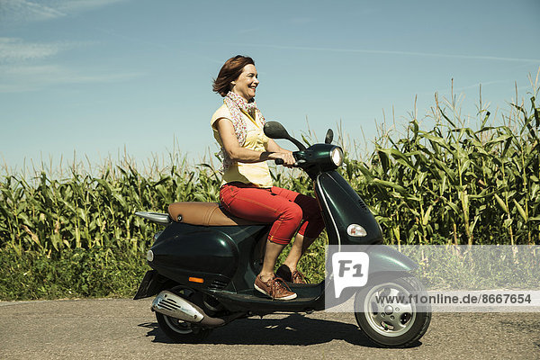 Woman riding on moped