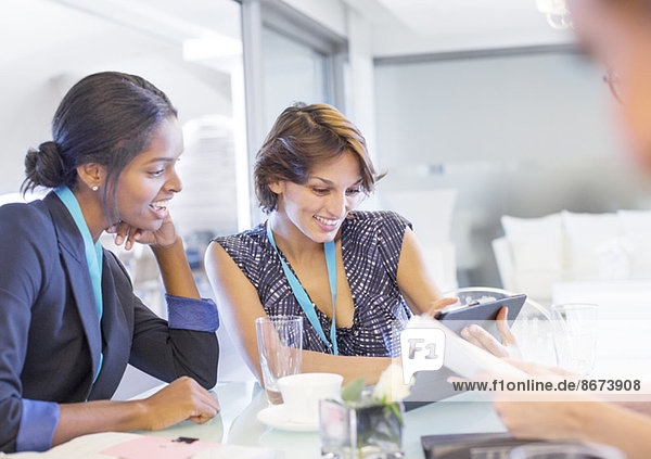 Businesswomen using digital tablet in meeting