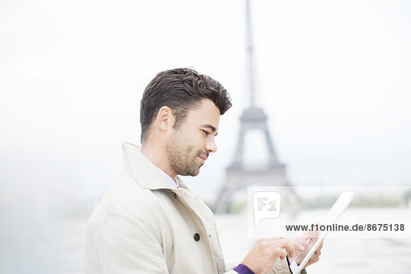 Geschäftsmann mit digitalem Tablett von Eiffelturm  Paris  Frankreich