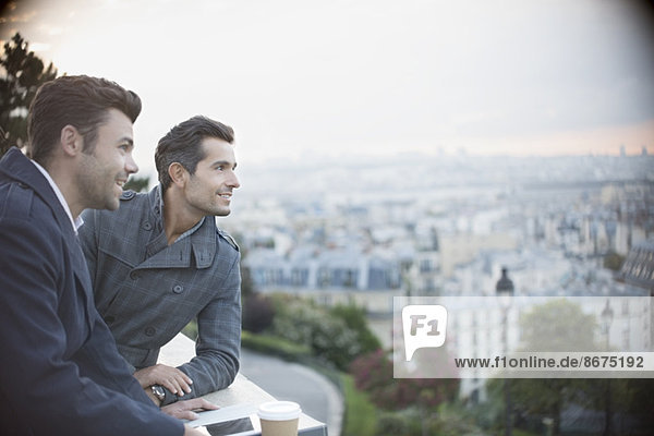 Businessmen overlooking cityscape  Paris  France