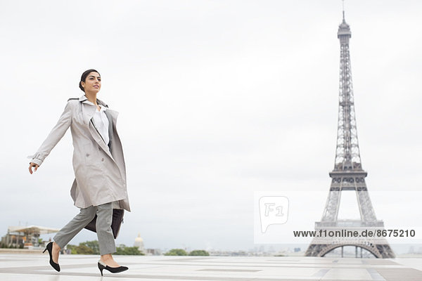 Businesswoman walking past Eiffel Tower  Paris  France