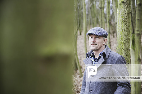 Portrait of man with cap in the wood
