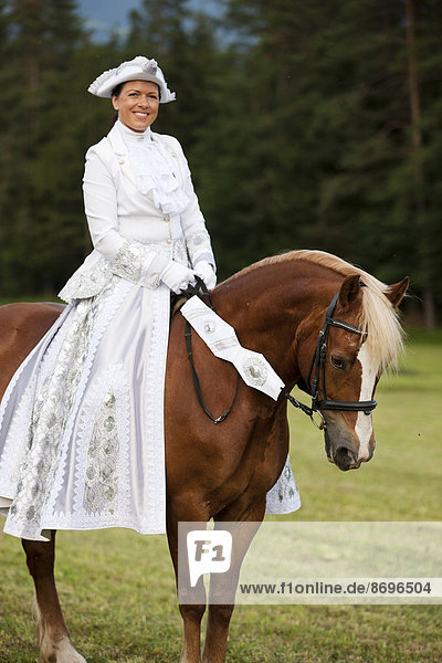 Equestrienne wearing a Venetian costume riding a Welsh Cob  sorrel  Northern Tyrol  Austria